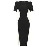 A black and white sheath dress displayed on a white background