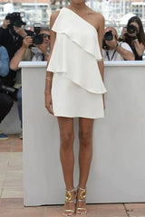 woman in a white one-shoulder ruffled dress