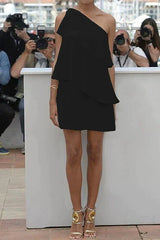 woman in a black one-shoulder ruffled dress