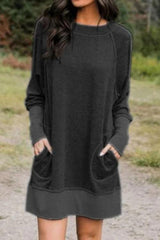 woman wearing a black long-sleeved dress with pockets