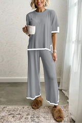 woman in grey loungewear set with white trim