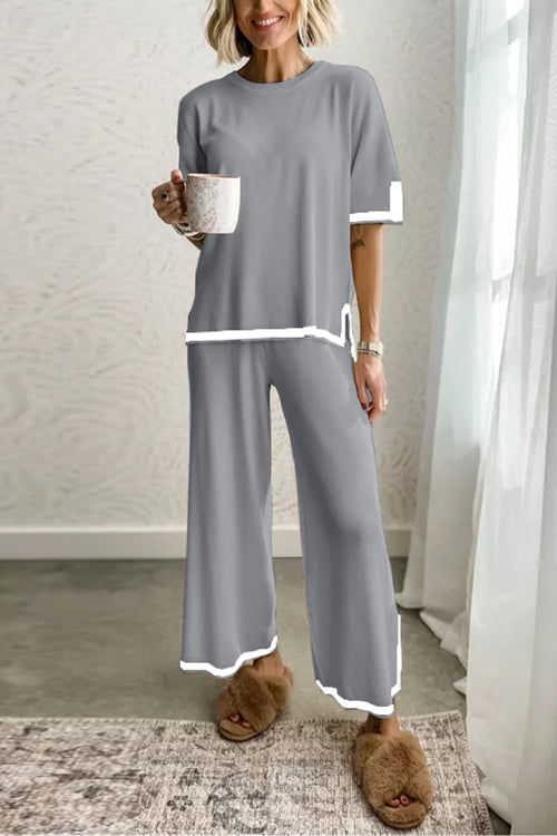 woman in grey loungewear set with white trim