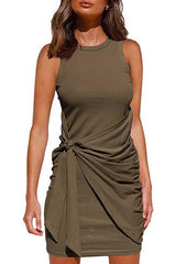 woman wearing an olive green ruched twist knot sleeveless mini dress