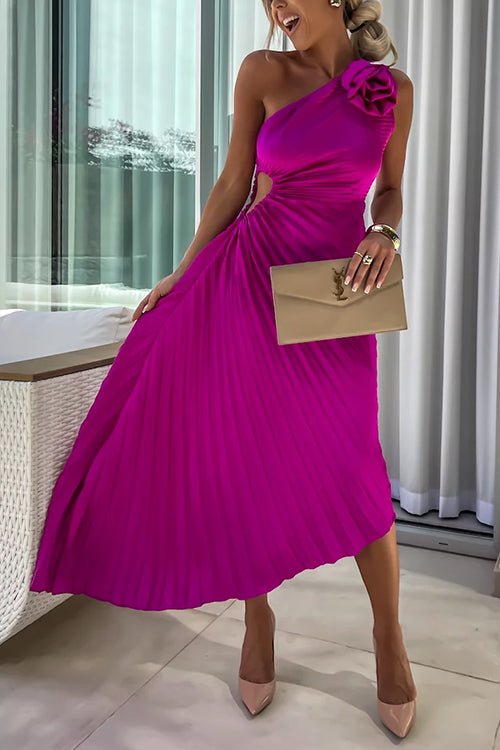 Woman wearing a magenta one-shoulder pleated dress with a floral embellishment and a clutch