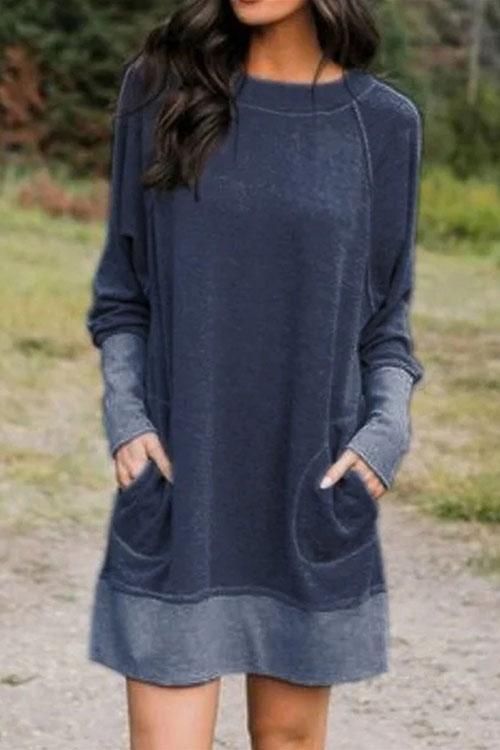 woman wearing a navy blue long-sleeved dress with pockets