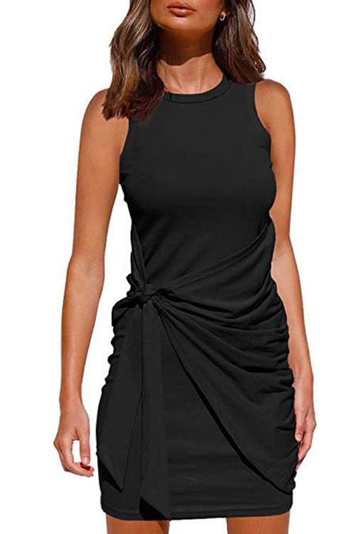 woman wearing a black ruched twist knot sleeveless mini dress