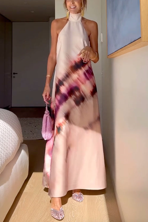 Woman in a pink and purple floral print halter neck maxi dress with sparkly shoes