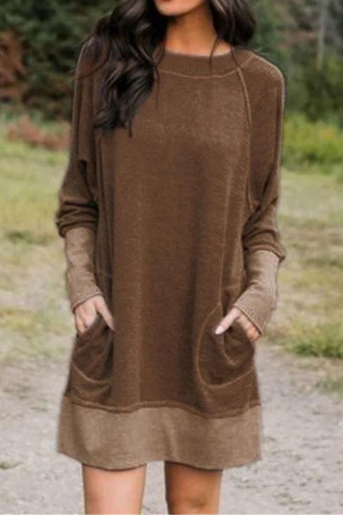 woman wearing a brown long-sleeved dress with pockets