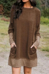 woman wearing a brown long-sleeved dress with pockets