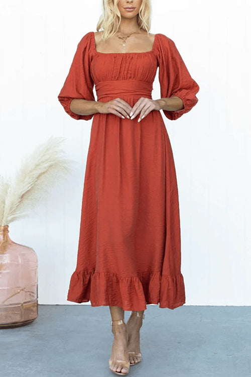 woman in a red midi dress with puff sleeves and a square neckline