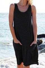 woman wearing a black sleeveless dress with pockets on a beach