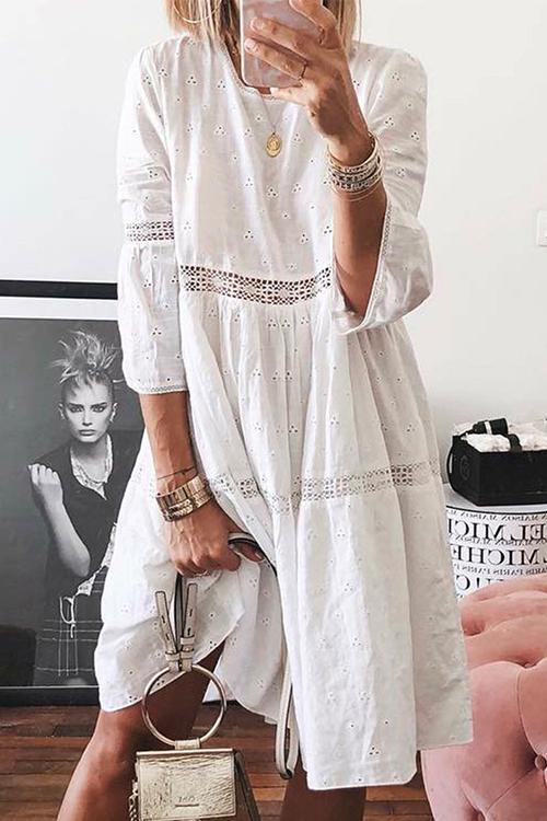 woman wearing a white eyelet midi dress