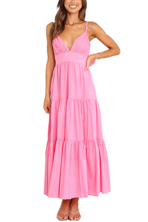 A pink tiered maxi dress with spaghetti straps and a v-neck, modeled on a white background.