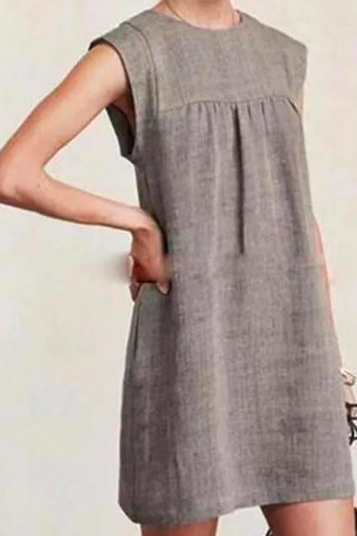 woman wearing a grey sleeveless dress
