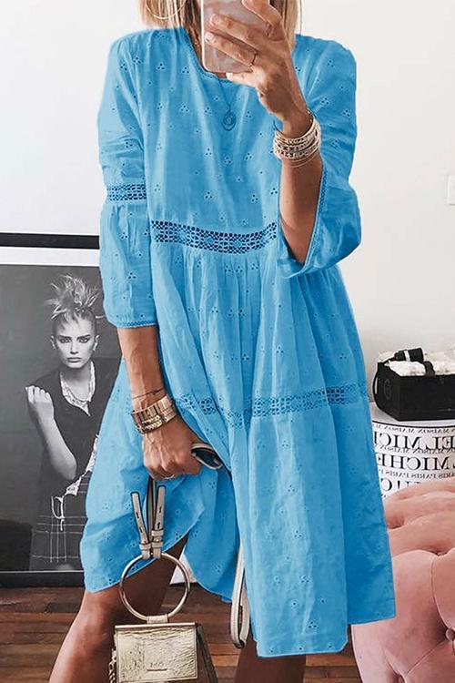 woman wearing a blue eyelet midi dress