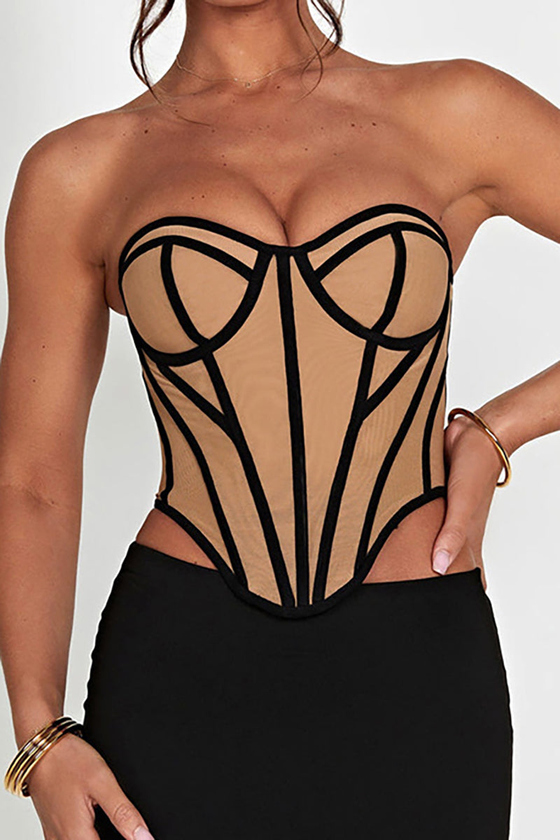 Front view of a woman wearing a tan and black strapless corset, showing the detailed paneling.