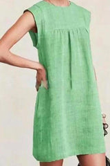 woman wearing a green sleeveless dress