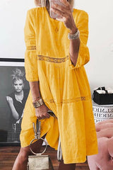 woman wearing a yellow eyelet midi dress