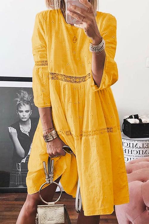 woman wearing a yellow eyelet midi dress
