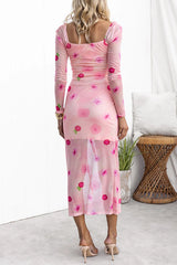 Back view of a woman in a pink floral mesh dress, showing the sheer back