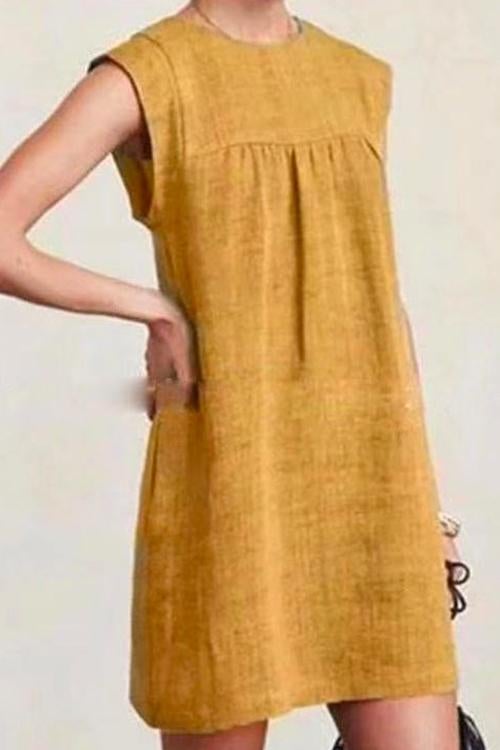 woman wearing a yellow sleeveless dress