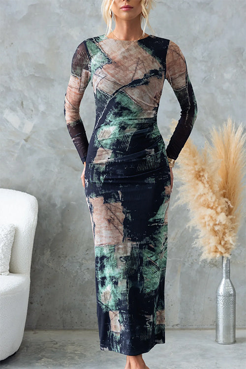 Front view of a woman modeling a long-sleeved, abstract print midi dress with a round neckline and ruched waist.