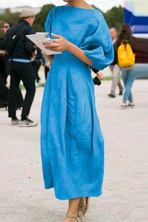 woman in blue midi dress with puff sleeves