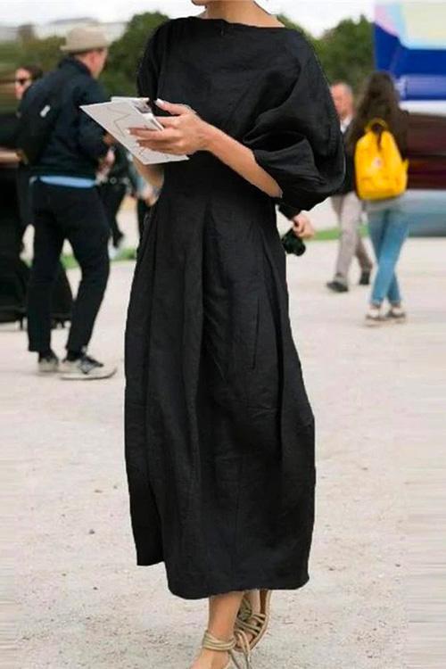 woman in black midi dress with puff sleeves