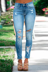 woman wearing light blue ripped skinny jeans with frayed hem and tan heels