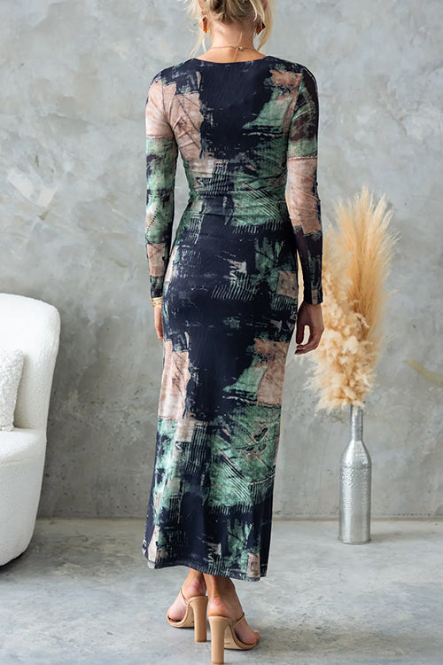 Back view of a woman wearing a long-sleeved, abstract print midi dress.