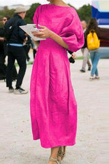 woman in pink midi dress with puff sleeves