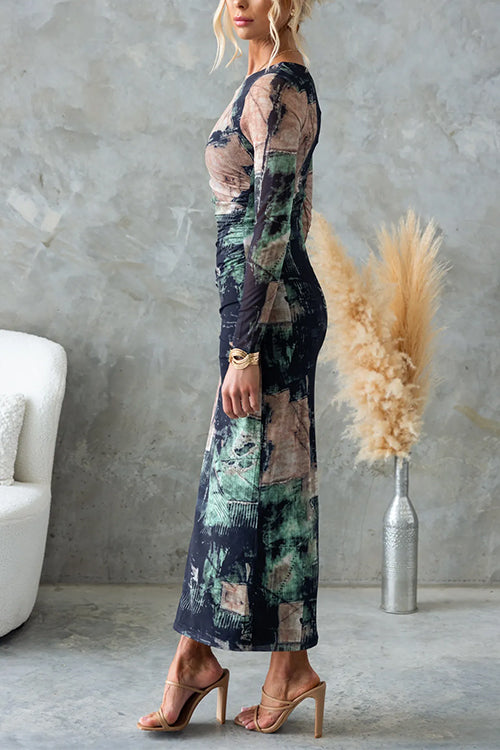 Side view of a woman in a long-sleeved, abstract print midi dress, showcasing the ruched detailing and sheath silhouette.