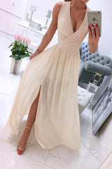 woman in a cream chiffon maxi dress with a high slit