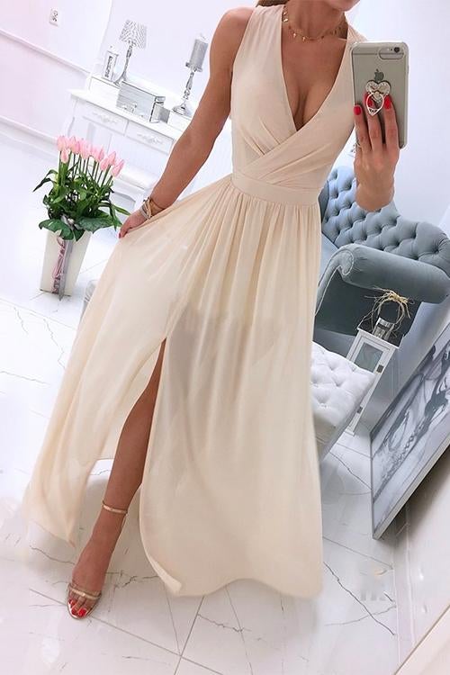 woman in a cream chiffon maxi dress with a high slit