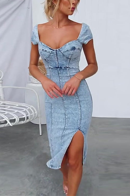 woman wearing a light blue denim sheath dress with a sweetheart neckline, cap sleeves, a high slit, and corset detailing
