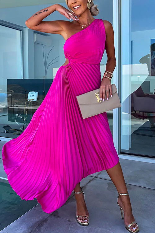 A woman in a fuchsia one-shoulder pleated dress with a cut-out detail and a beige clutch.