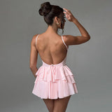 Woman in a pink ruffled dress from the back