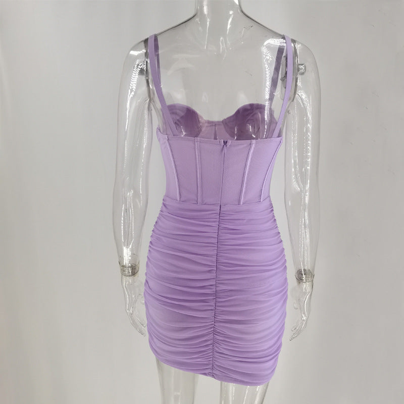 Back view of a lavender ruched mini dress with a corset bodice on a mannequin