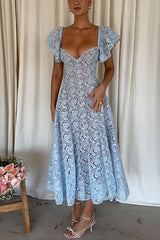 Full body shot of a woman wearing a light blue lace midi dress