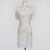 A white sequined dress with cap sleeves and a high neckline displayed on a mannequin.