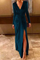 woman in a teal velvet dress with a high slit