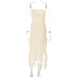 Back view of a cream strapless ruched midi dress with ruffled asymmetrical hemline and high slit on a mannequin.
