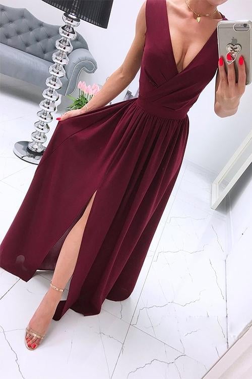 woman in a maroon chiffon maxi dress with a high slit