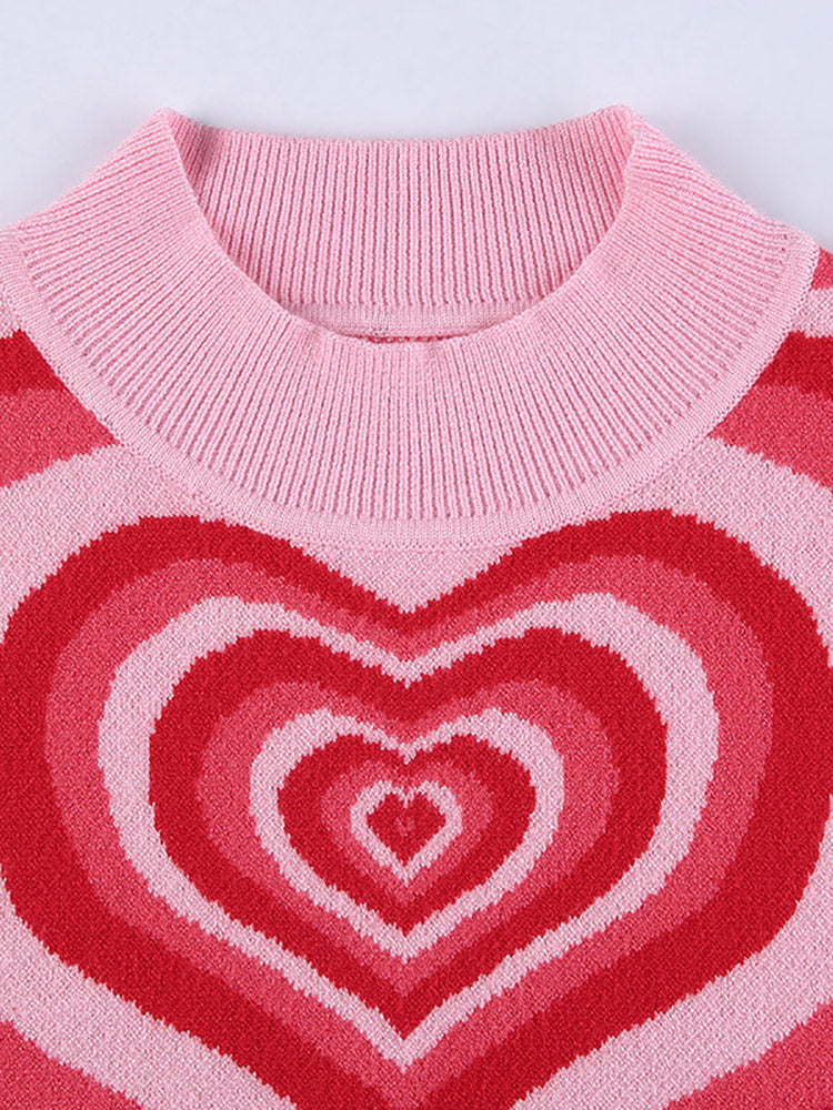 Close-up of the mock neck and heart pattern on a pink and red striped knit top.
