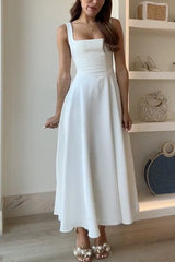 A woman wearing a white sleeveless midi dress with a square neckline.