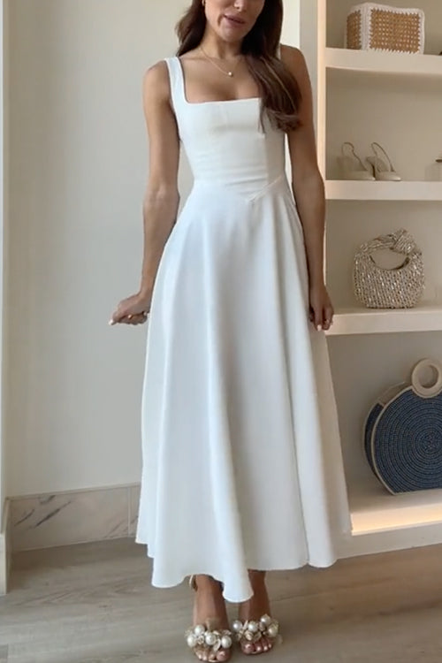 A woman wearing a white sleeveless midi dress with a square neckline.