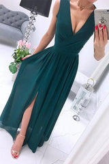 woman in an emerald green chiffon maxi dress with a high slit