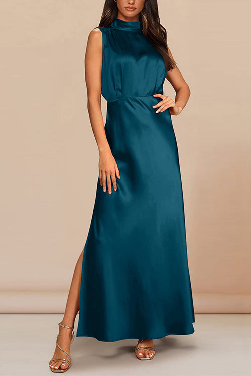Woman wearing a teal satin maxi dress with a high neckline, sleeveless design, and a high slit on the leg, posed against a neutral background.