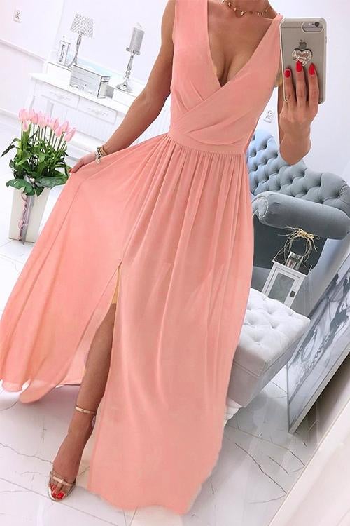 woman in a peach chiffon maxi dress with a high slit