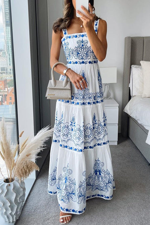 full length view of a woman in a white and blue embroidered maxi dress